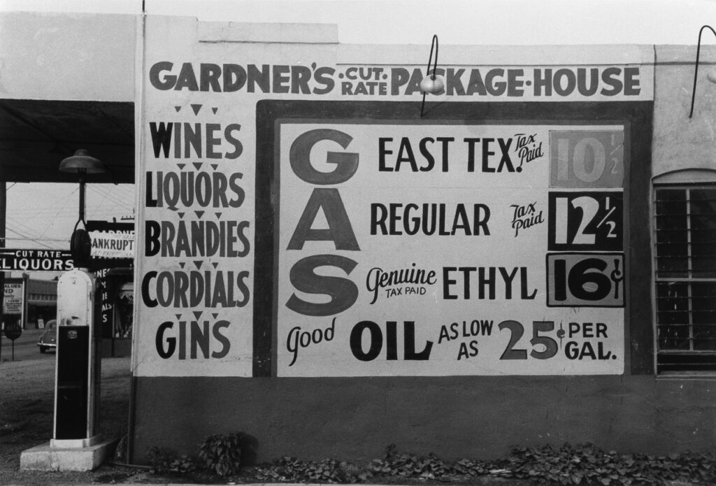 Russell Lee (1903 - 1986). Sign at a filling station which also sells liquor. Waco, Texas. November 1939.