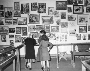 Russell Lee (1903-1986), The Gonzales County Fair. Lookig at the art exhibit. Gonzales, Texas. November, 1939. gift of the Hartnell Fine Arts Club