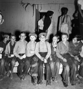 Dorothea Lange (1895 - 1965). The Farm Security Administration camp for migratory workers. Children at the Halloween party, waiting for the signal to come for refreshments. Shafter, California. November 1938. Gift of Annelies Vanderberg, Salinas, CA.