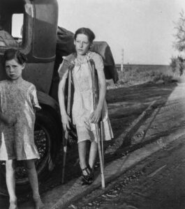 Dorothea Lange (1895 - 1965). Children of Oklahoma drought refugees on the highway. Family of six, no shelter, no food, no money and almost no gasoline. The child has bone tuberoulosis. Bakersfield (vicinity), California. June 1935.