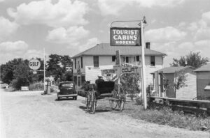 Marion Post Wolcott (1910 - 1990). A grocery store, bar, gasoline station and tourist cabins along the highway. Bardstown (vicinity), Kentucky. August 1940.