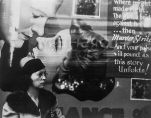 John Vachon (1914 - 1975). Girl and movie poster. Cincinnati, Ohio. October 1938.