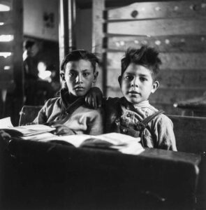 John Collier Jr. (1913 - 1992). One-room school in an isolated mountainous Spanish-American community, which has eight grades and two teachers. Most of the teaching is in Spanish, the language spoken in the children's homes, and as a result they rarely speak English fluently. Ojo Sarco, New Mexico. January 1943.
