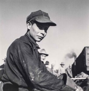 Jack Delano (1914 - 1997). A young Indian laborer working in the Atchison, Topeka and Santa Fe railroad yard. Winslow, Arizona. March 1943.