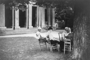 Marion Post Wolcott (1910 - 1990). Townspeople and farmers playing cards in front of the courthouse on a Saturday afternoon. Yanceyville, North Carolina. September 1939.
