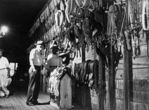 John Vachon (1914 - 1975). A customer in the saddle shop. San Augustine, Texas. April 1943.