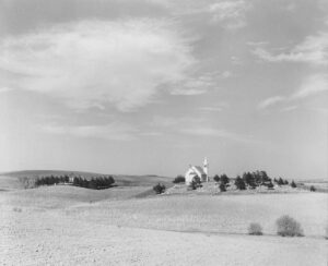 John Vachon (1914 - 1975). Country church and cornfield. Monona County, Iowa. May 1940.