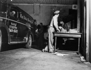 John Vachon (1914 - 1975). Loading bundles of the Dallas Morning News into trucks for delivery. Dallas, Texas. April 1943.