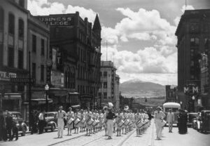 Arthur Rothstein (1915 - 1985). High school band parading up Montana Street. Butte, Montana. Summer 1939. Gift of Dr. and Mrs. Gibb R. Madsen, Salinas, CA.