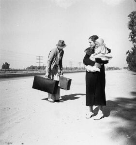 Dorothea Lange (1895 - 1965). Young penniless family, hitchhiking. The father, 24 and the mother, 17, came from Winston Salem, North Carolina. Early in 1935, their baby was born in the Imperial Valley, California where they were working as field laborers. US Highway 99, California. November 1936.