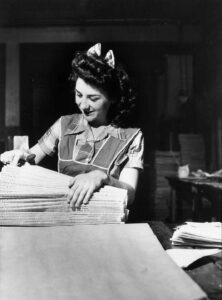John Vachon (1914 - 1975). Girl preparing newspapers for mailing in bundles in the office of the Beaumont Journal. Beaumont, Texas. May 1943.