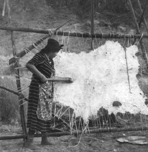 Dorothea Lange (1895 - 1965). Method of scraping hide for softening. Indian fishing village, Oregon. October 1939.