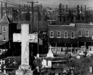 Walker Evans (1903 - 1975). Graveyard, Houses, and Steel Mill. Bethlehem, Pennsylvania. November 1935.