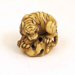 Tiger on a rock, sculpture, ivory, artist unknown